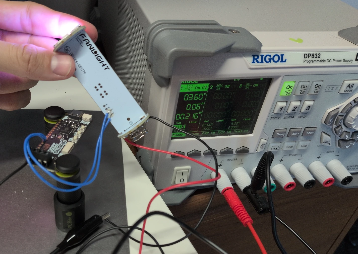 Testbench composed of the DXTEEN Fanlight, Rigol Power Supply, and our debugger